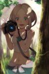  1girl anchiko bad_id blonde_hair camera capri_pants crop_top dappled_sunlight forest grass green_eyes gym_leader holding long_hair midriff nature navel nintendo open_mouth pants pokemon pokemon_(game) pokemon_xy solo sports_bra sunlight tree tree_shade under_tree viola_(pokemon) 